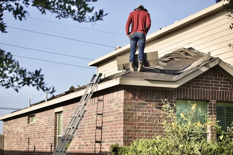 Professional roofer working on a residential roof in East Sharpsburg